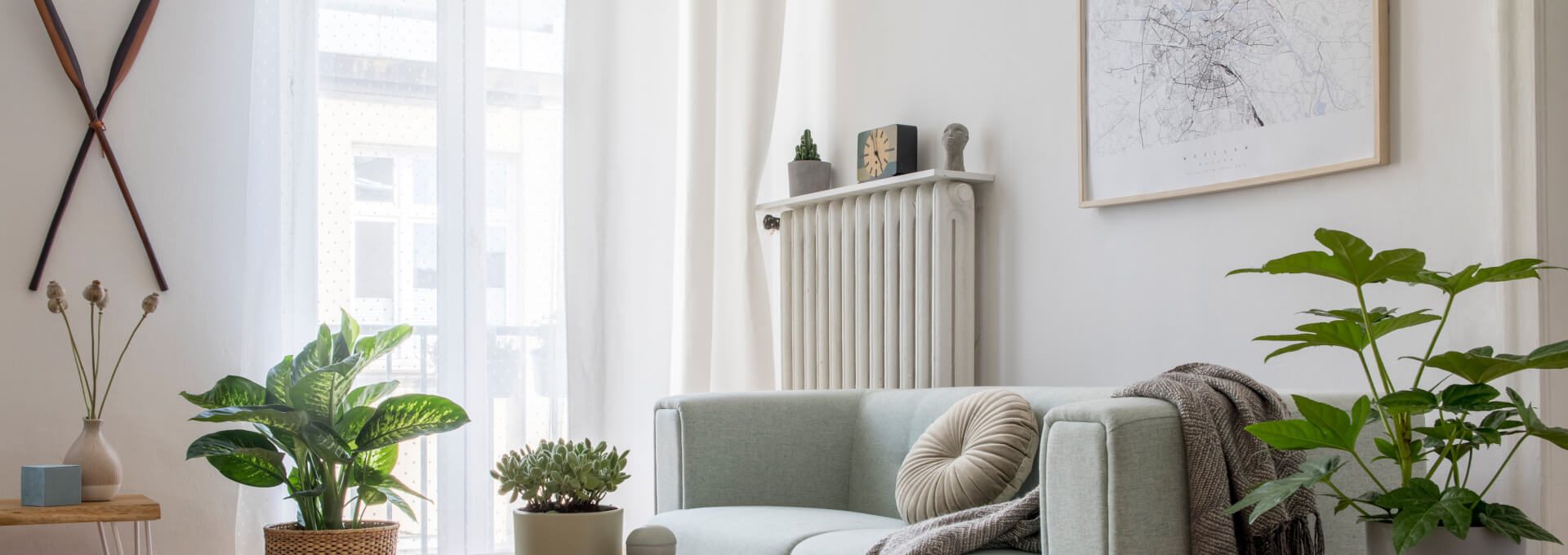 a living room with a couch, coffee table and plants at The  Sutton