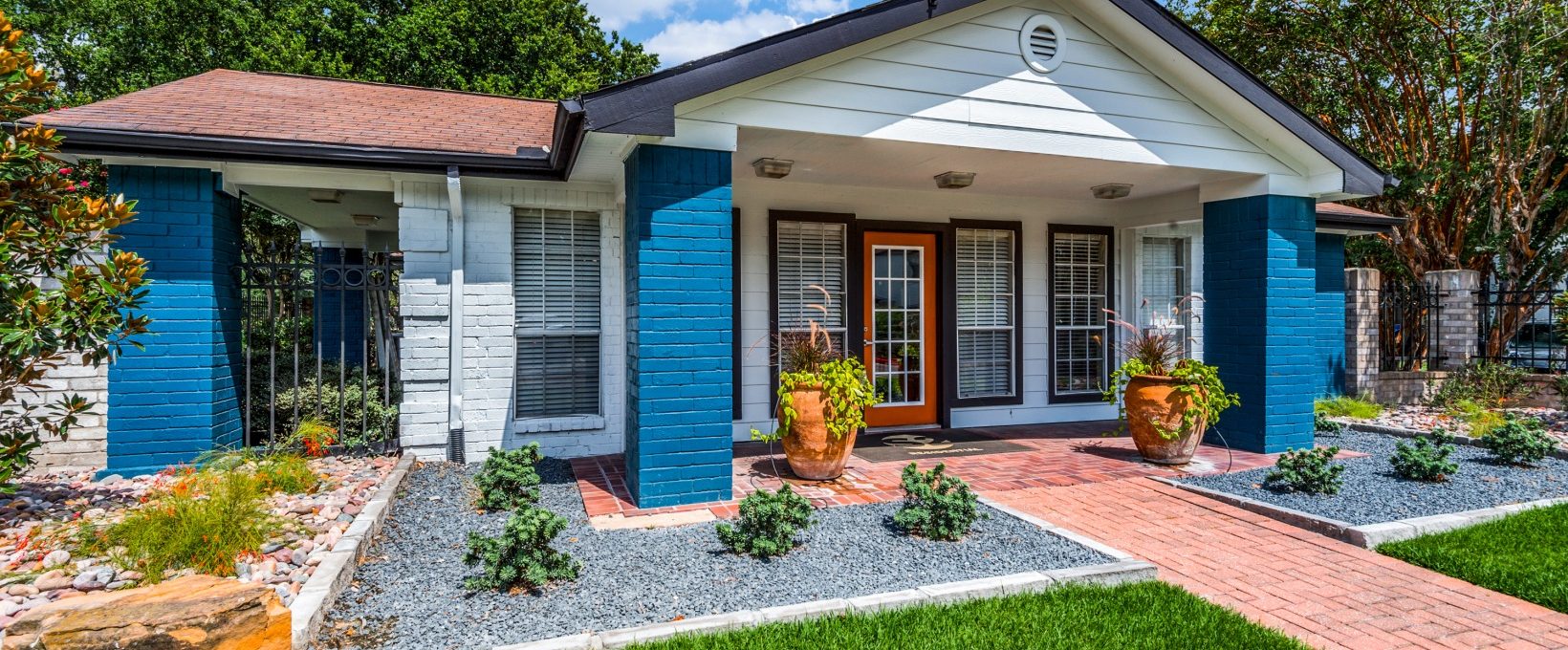 a blue house with a front yard and green grass at The  Sutton