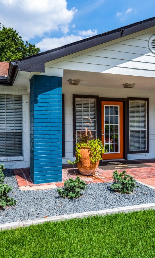 a blue house with a front yard and green grass at The  Sutton