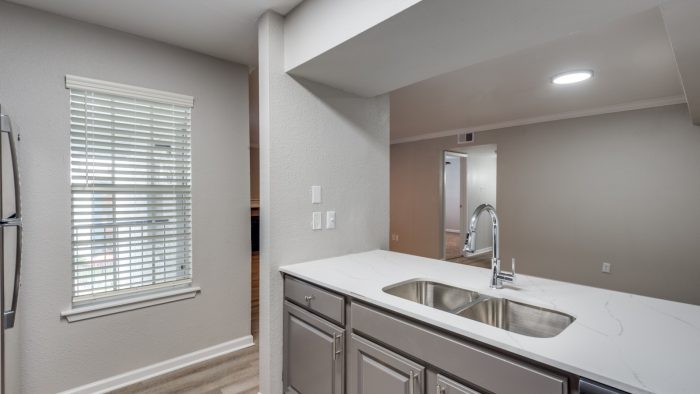 a kitchen with a sink and stainless steel appliances at The  Sutton