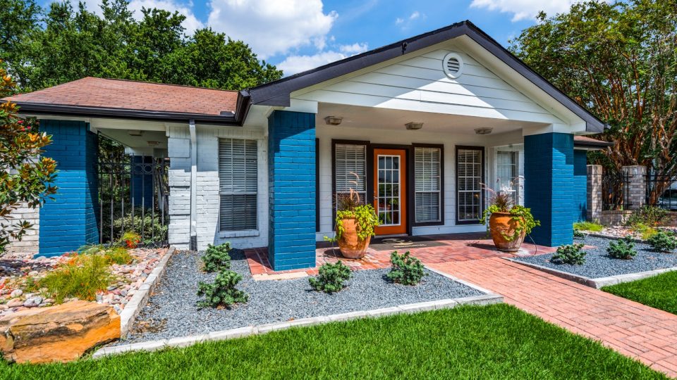 a blue house with a front yard and green grass at The  Sutton