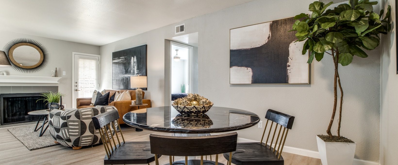 a dining room with a table and chairs and a fireplace at The  Sutton