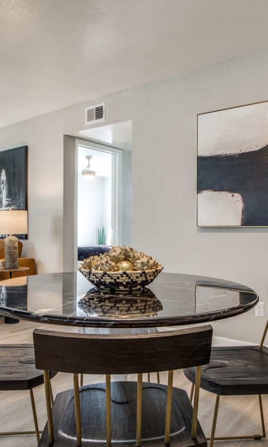 a dining room with a table and chairs and a fireplace at The  Sutton