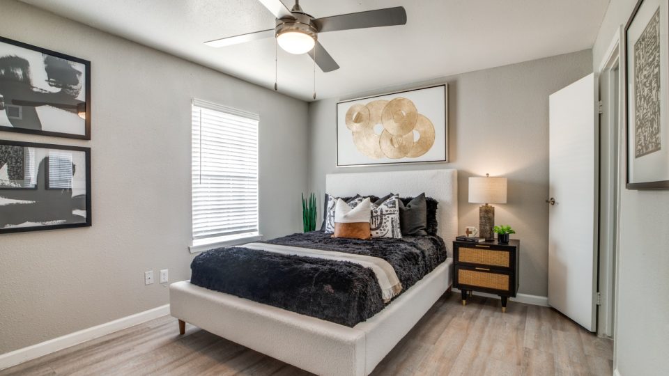 a bedroom with a ceiling fan and hardwood floors at The  Sutton