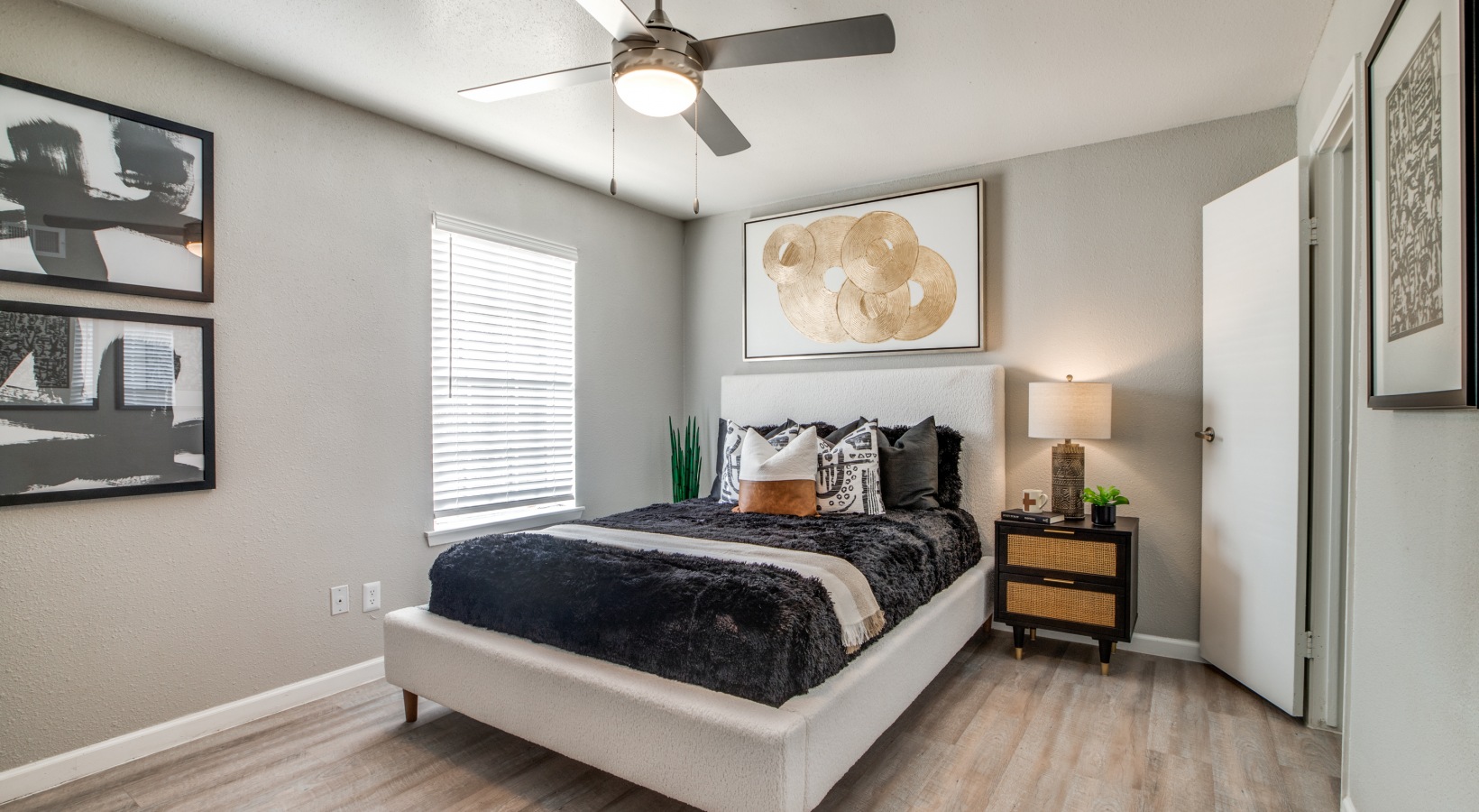 a bedroom with a ceiling fan and hardwood floors at The  Sutton