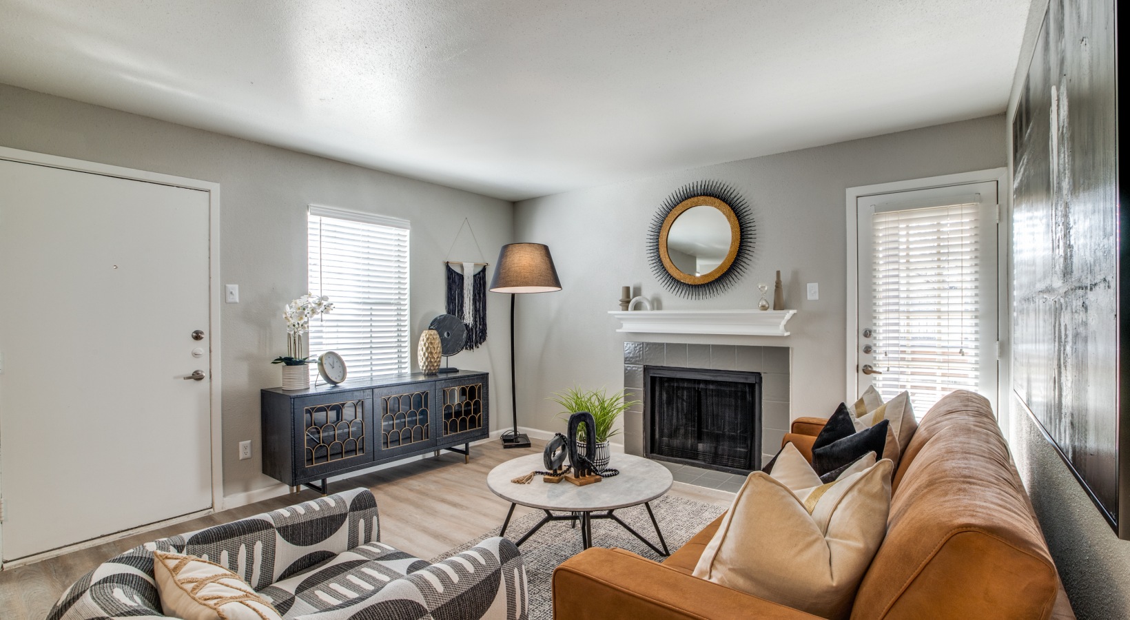 a living room with a fireplace and a couch at The  Sutton
