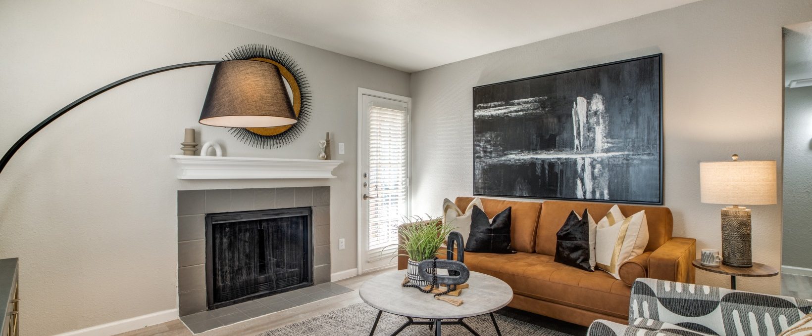 a living room with a fireplace and a large painting at The  Sutton