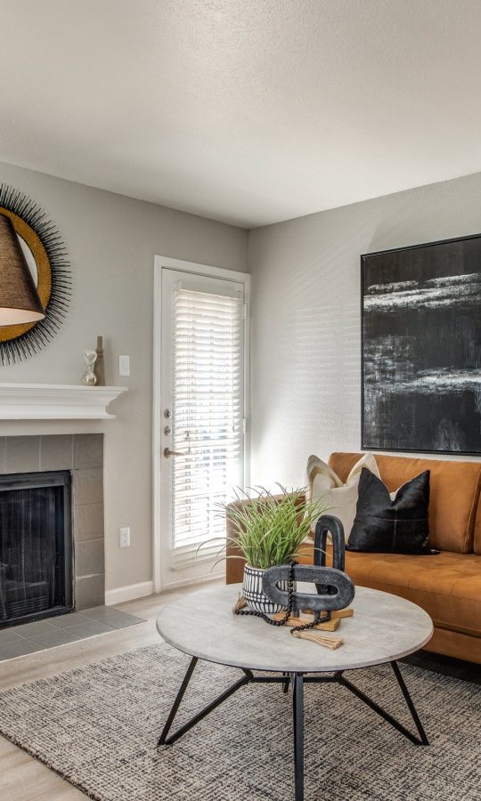 a living room with a fireplace and a large painting at The  Sutton
